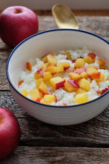 Rice pudding with apple. Side view, wooden background