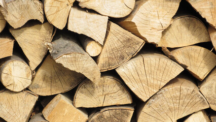 stack of firewood. Chopped wooden logs stacked in the woodpile