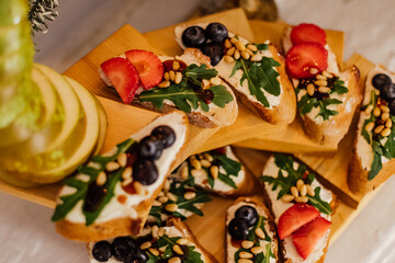 bruschetta with strawberries and arugula. bruschetta with cheese and blueberries and sauce