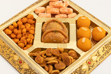 Indian Shahi Mithai Gujia Or Gujiya, Spicy Crispy Snacks Namkeen Also Called Nimki, Mathri, Matar, Kachori, Mixture Decorated in Giftbox. Food Theme For Holi, Deepawali, Rakshabandhan, Dussehra, Rakhi