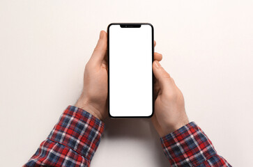 Man with smartphone on white background, top view