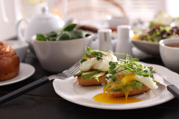Delicious sandwiches with eggs and avocado served on buffet table for brunch
