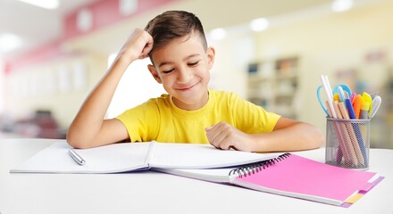 Smiling elementary school boy while studying in the class