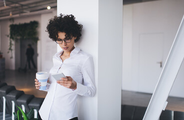 Millennial business woman use smartphone in office
