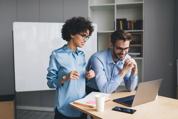 Millenial business man and woman working in office