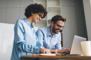 Millenial business man and woman working in office