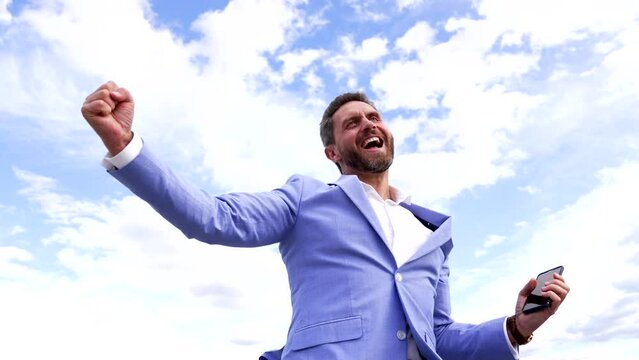 Happy professional employee scream making winning gesture on sky, career promotion