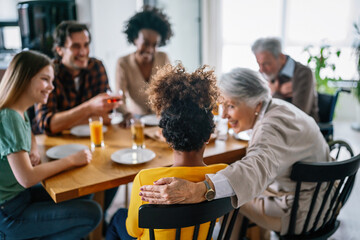 Happy multiethnic multigeneration family with husband, wife, children, grandfather and grandmother