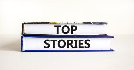 Top stories symbol. Concept words Top stories on books on a beautiful white table white background. Business story and top stories concept, copy space.