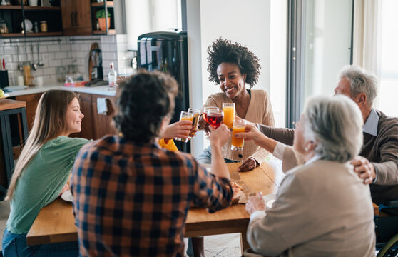 Multiethnic Diverse Extended Family Dining And Toasting Together