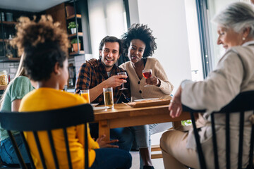 Multiethnic diverse extended family dining and toasting together