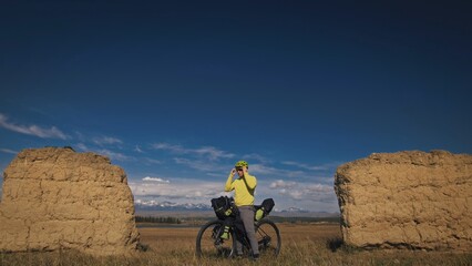 The man travel on mixed terrain cycle touring with bikepacking. The traveler journey with bicycle...