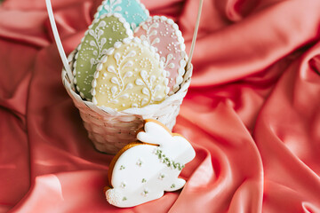 background banner greeting card for Happy Easter with set colorful eggs gingerbread cookies in basket on pink silk fabric background