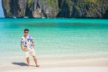 happy tourist man at Maya Bay beach on Phi Phi island, Krabi, Thailand. landmark, destination...