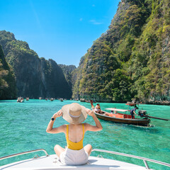 Woman tourist on boat trip, happy traveller relaxing at Pileh lagoon on Phi Phi island, Krabi,...