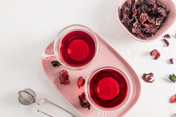 top view of glass transparent cups with hibiscus tea made of dry rose petals. delicious healthy drink, vitamin tea for colds and flu.