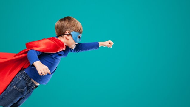 Content superhero kid in mask demonstrating power