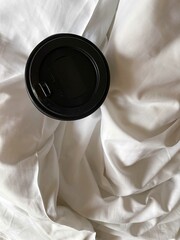 Takeaway coffee cup on the bed