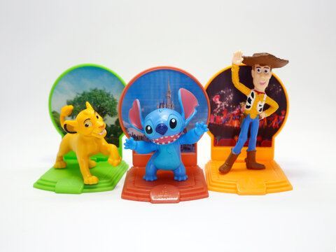 McDonald's happy meal toys in commemoration of the Walt Disney World 50th Anniversary celebration. Plastics figures. Isolated white. Woody, Simba, Stitch. Toy Story, The Lion King, Lilo and Stitch. 