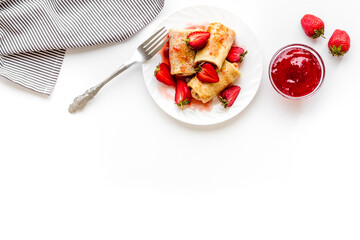 Hot french crepes with strawberry and berry sauce. Sweet dessert