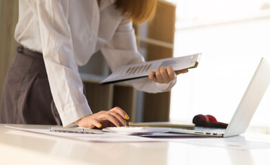 Accountants use calculators and laptops to calculate their finances and plan their finances on their desks. business financial accounting concept.