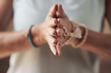 Balancing my chakras. Cropped shot of an unrecognizable woman standing with her palms together while meditating indoors. - obrazy, fototapety, plakaty