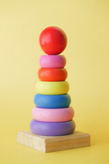 Child development and learning toys on yellow background 