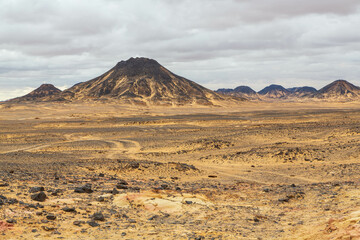 Fototapeta na wymiar Volcanic mountains in Black Desert near the Bahariya Oasis in Egypt.