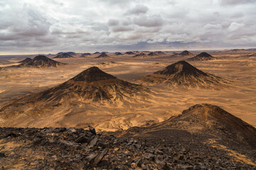Naklejka premium Volcanic mountains in Black Desert near the Bahariya Oasis in Egypt.
