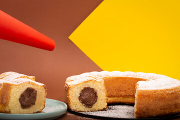 Home made pound cake with chocolate filling in a studio shot with cheerful, pastel and modern colors set