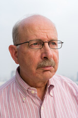 Obraz premium Portrait of senior man face thinking outdoors in city