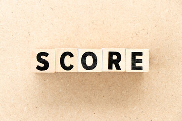 Alphabet letter block in word score on wood background