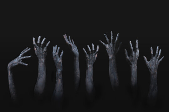 many scary and creepy zombie hands raising from darkness