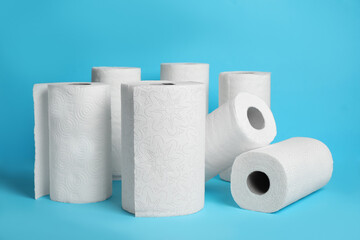 Many rolls of paper towels on light blue background