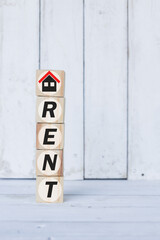 rent word or concept on wooden blocks, white wood background