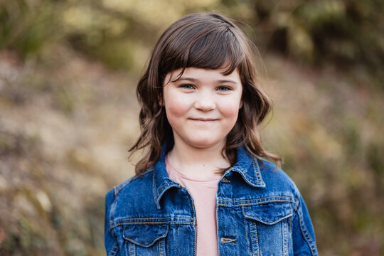 Charming girl in denim jacket in nature