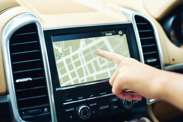Fototapeta premium Finding locations the efficient and easy way. Shot of an unrecognizable woman using a gps in a car.