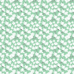Cute seamless pattern with white blooming magnolias twigs.