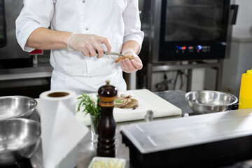 Obraz na płótnie Canvas Chef cuts the shrimp. Concept of mediterranean cuisine.