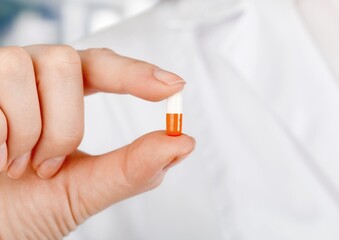 Medical oral capsules, antiviral drug of covid 19 concept in doctors hand.