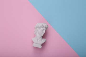 David bust on pink blue background. Cretive layout. Minimal still life. Flat lay. Top view