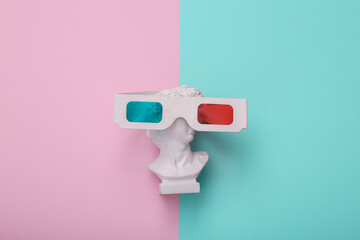 David bust with 3d glasses on pink blue background. Creative layout. Minimal still life. Flat lay....