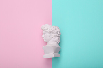 David bust on pink blue background. Creative layout. Minimal still life. Flat lay. Top view