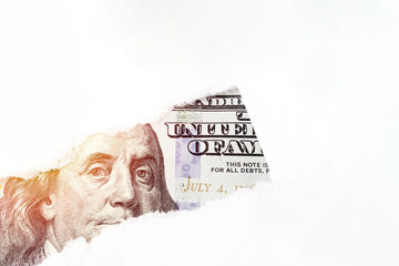 US 100 dollar bill close up in torn paper hole, Portrait of US president Benjamin Franklin on 100...
