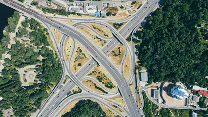 Top view of cars driving along the highway overpass. Traffic on the city road