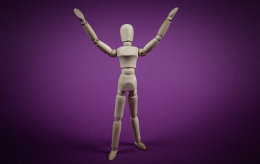 Happy wooden puppet mannequin on a purple background.