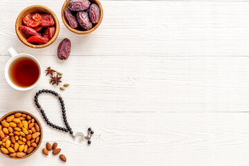 Ramadan Kareem concept. Islamic rosary with star and crescent and dates fruits