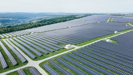 Aerial view of a large energy farm of industrial solar panels built in a row