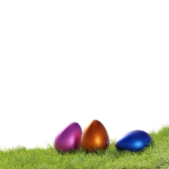 Three Easter eggs on grass on white background, Easter concept