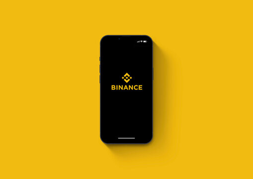 Binance cryptocurrency exchange app on the smartphone iPhone 13 screen. Yellow background. Rio de Janeiro, RJ, Brazil. March 2022